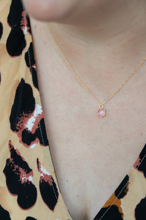 Open image in slideshow, A close up of a woman&#39;s neck wearing the simple chain in yellow gold with the spinel charm from the huggie hoop earring on it.
