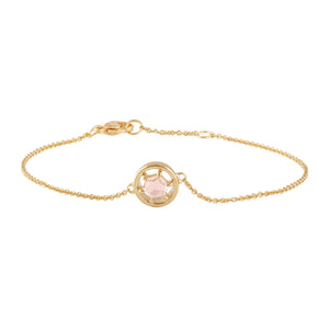 a detailed image of the gold and spinel bracelet. The spinel is a rose cut hexagonal shape, with a circle of gold around it on a delicate gold chain.