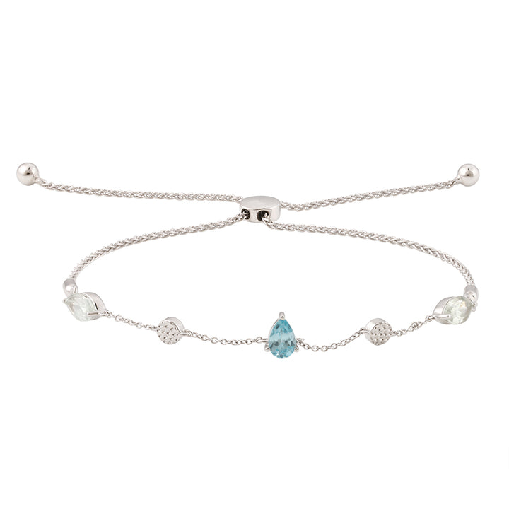 The Monteverde line style bracelet with a bolo closure in silver features two hammered disks, two marquise cut prasiolites and one pear cut blue zircon on a white background #color_silver